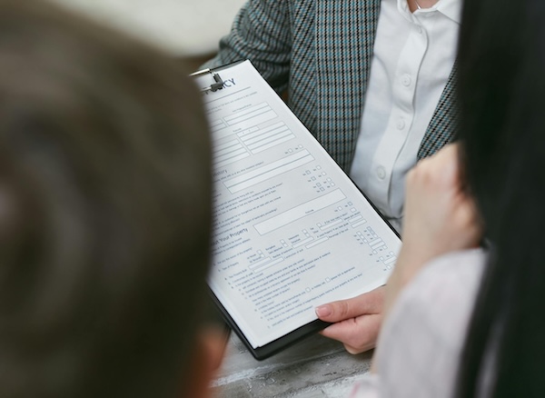 Two prospective tenants review a lease agreement